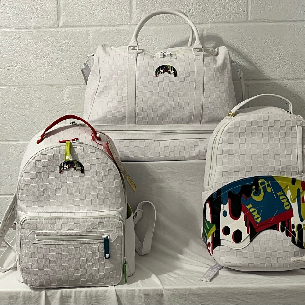 Limited edition sprayground luggage bag and 2 backpacks.